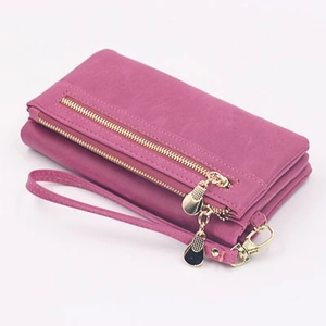 Detail of purple PU leather long wallet featuring double zippers and a wrist strap
