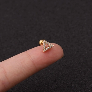 Minimalist gold triangular crown labret stud with white zircon on fingertip