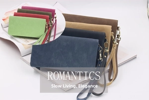 Multiple colorful vintage long wallets with wrist straps and golden metal hooks