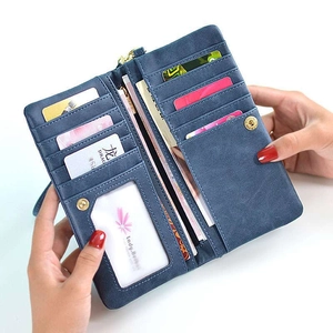 Detail view of the deep blue long wallet's interior slots and golden zipper closure