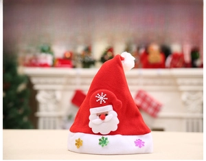 Detail showing plush Christmas hat with Santa Claus figurine and colorful sequins