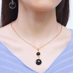 Elegant gold-plated stainless steel jewelry set featuring faceted black round gemstones