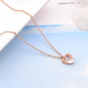 Close-up of rose gold double heart pendant necklace with a sparkling zircon inlay