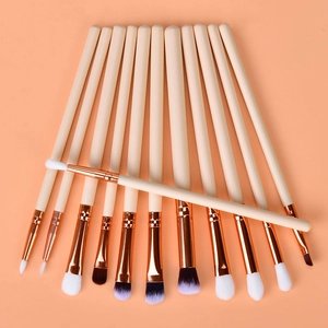 Detail of 12-piece eye makeup brush set with rose gold ferrules and purple gradient bristles