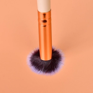 Detail of soft purple gradient bristles and rose gold ferrule on makeup eye brush