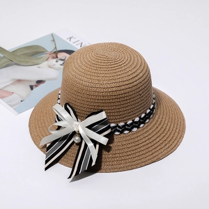 Brown straw sun hat with black and white bow ribbon and pearl pendant detail