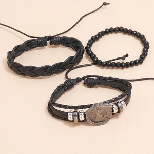 Three-piece black braided leather bracelet set with metallic playing card charm details