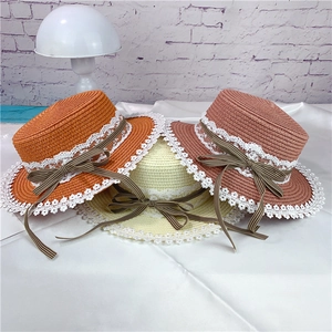 Straw sun hats with lace trim and checkered bows in orange, beige, and pink colors