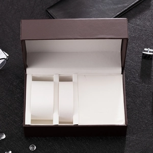 Detailed top view of a brown leather jewelry and watch organizer box with three compartments