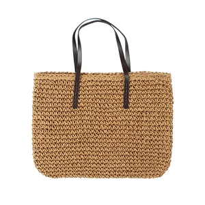 Handwoven straw tote bag with brown leather handles for summer beach vacations