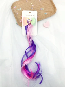 Detail of rainbow unicorn bow hair clip with long pink and purple gradient curly wig extension