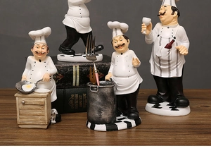 Detail view of four handcrafted resin chef figurines with diverse culinary poses on wood