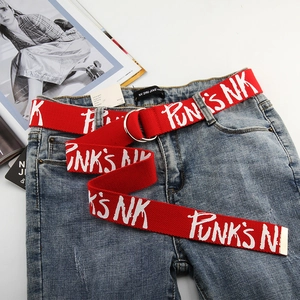 Detail of red canvas belt with white graffiti punk text and silver double ring buckle