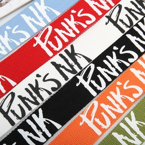 Detail view of colorful punk letter print canvas belts with double ring buckles for jeans
