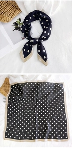 Close-up of black silk square scarf with white polka dots and beige contrast edge