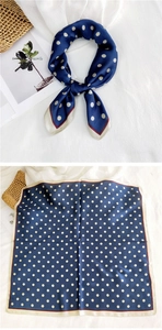 Detailed view of polka dot square silk scarf with red contrast stitching and beige border