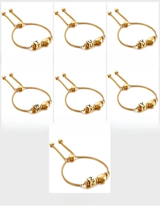 Close-up of golden adjustable bracelets featuring heart pendants and letter charms T to Z