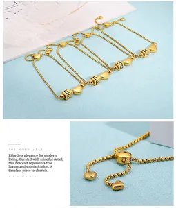 Detail of adjustable golden stainless steel heart bracelet with initial letter charms