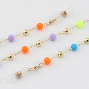 Golden eyewear chain with vibrant jelly beads and lobster clasps on white background