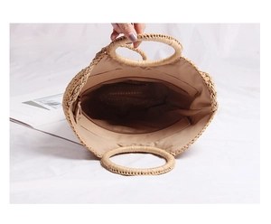 Top view showing the spacious interior lining of the woven straw beach handbag