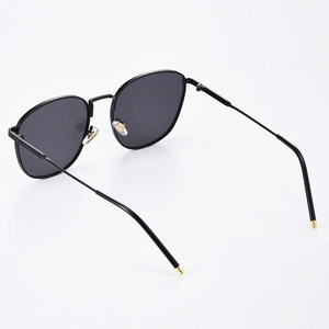 Modern square frame sunglasses with black lenses and gold metal temple tips