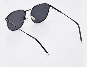 Detailed view of black square frame sunglasses with metal temples and nose pad design