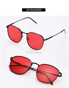 Detail view of square black metal sunglasses with translucent red ocean lenses