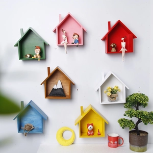 Set of seven colorful wooden house-shaped floating wall shelves for creative home decor