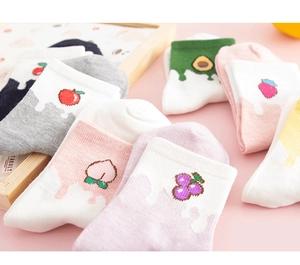 Detailed close-up of cotton socks with cute fruit patterns like strawberry and avocado