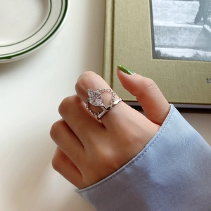 Close-up of 925 sterling silver ring with heart-shaped zircon and chain-link band