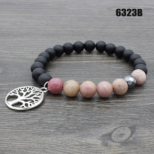 Detail of beaded yoga bracelet with tiger eye stone and silver Tree of Life charm