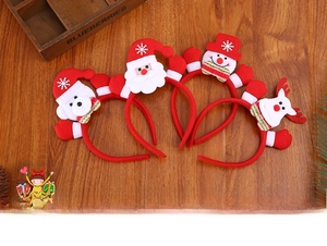 Flachbild von vier Weihnachts-Haarreifen mit Weihnachtsmann-, Bär-, Schneemann- und Rentier-Motiven
