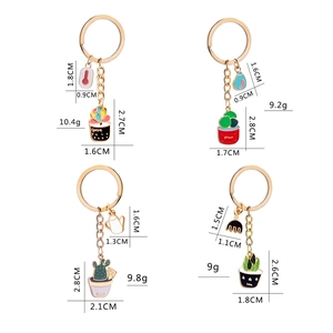 Detail view of colorful cactus and gardening tool enamel keychains with dimension specs