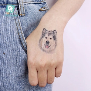 Temporary husky dog tattoo sticker for kids applied on a model's hand back