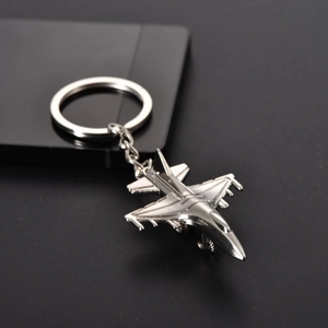 Detailed view of silver metal fighter jet keychain showing metallic texture and finish