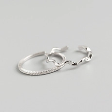 Detailed view of silver layered rings featuring wavy textures and striped patterns