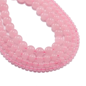 Natural pink rose quartz round beads for DIY jewelry making in various sizes on white background