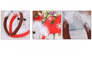 Detail of Christmas reindeer antler headband featuring soft white feathers and gold bells