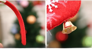 Detail of red Christmas headband with soft velvet edge, metal bell and snowflake charm