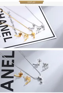 Detail of dolphin necklace and stud earrings set in polished gold and silver finishes