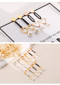 Detail of heart-shaped pearl long earrings in gold, silver, rose gold and black finish