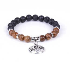 Lava stone and wood beaded bracelet with silver tree of life charm on white background