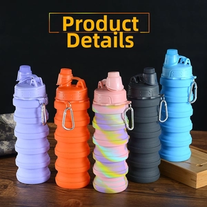 Collapsible silicone water bottles in five colors with metal carabiners on wood surface