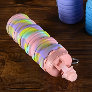 Macro detail of the spiral texture on a rainbow tie-dye collapsible silicone water bottle