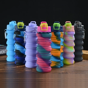 Variety of colorful collapsible silicone sports water bottles arranged on a wooden surface