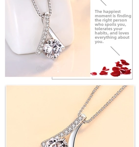 Macro detail of S925 sterling silver necklace with ribbon pendant and cubic zirconia stone