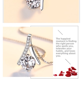 Detail of S925 silver pendant featuring a round clear gemstone and a delicate box chain