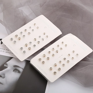 Detail of 12-pair stud earring set with gold and silver six-prong cubic zirconia crystals