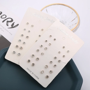 12-pair set of silver-toned stud earrings with round claw-set rhinestones on display cards