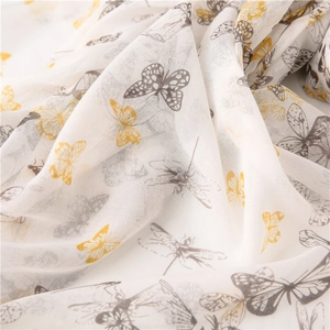 Detail shot of lightweight white scarf featuring elegant grey and yellow butterfly prints